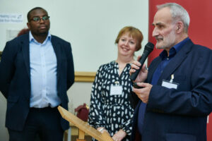 Cllr Okereke, and Sarah Murray with Tony Goldstein speaking at the celebration event.