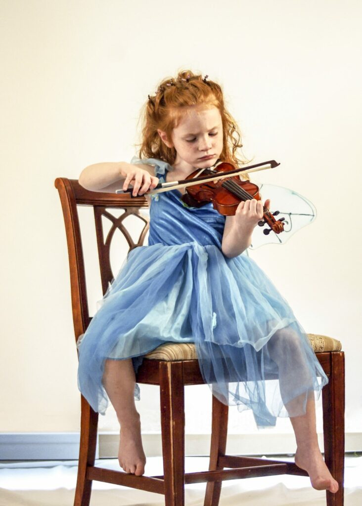Photo of young girl playing violin