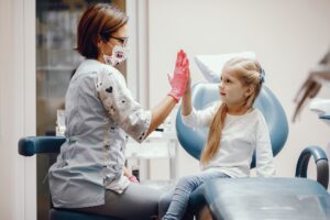 Health care worker and child high fiving