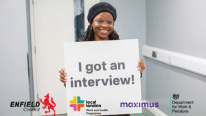 Happy resident from Enfield who got an interview on the day holding a board saying 'I got an interview'