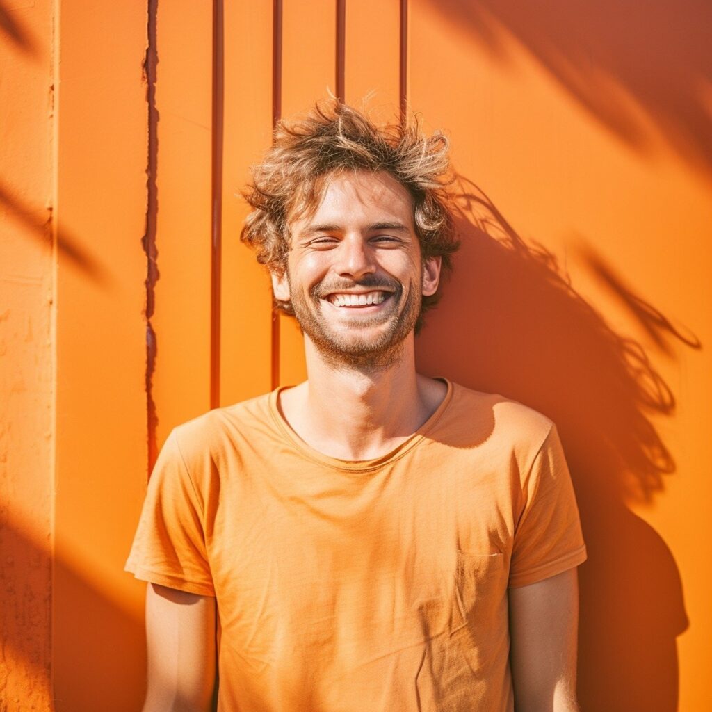 Smiling man wearing orange t-shirt