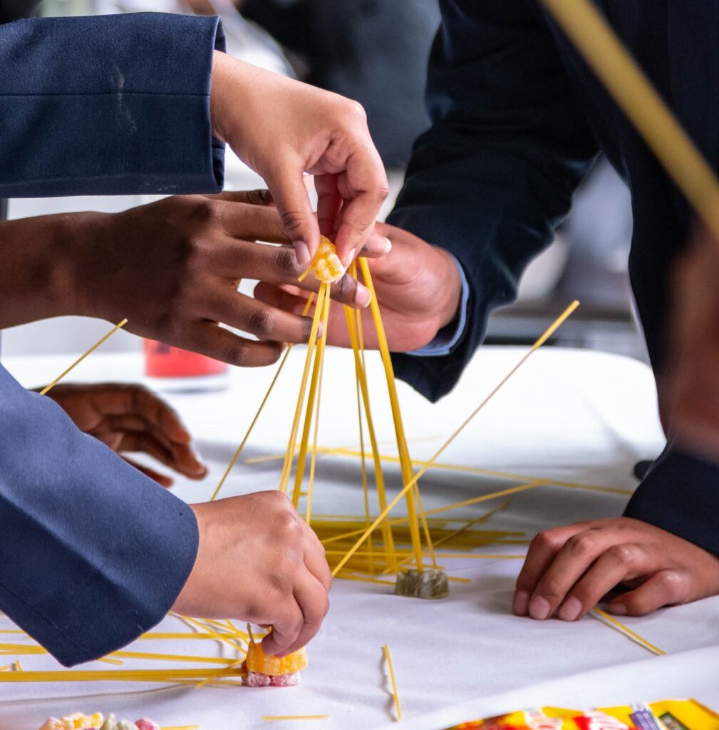 Students building a tower with dried spaghetti